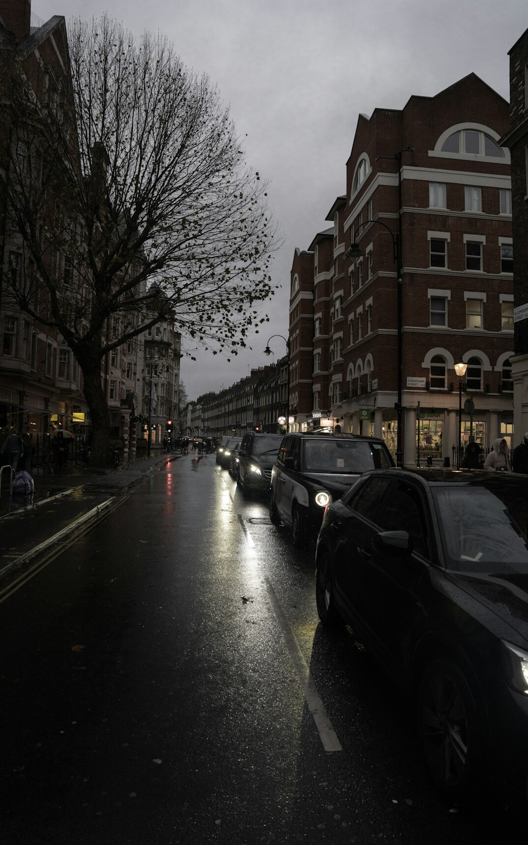 Clean dark sedan seen from the front on a road
