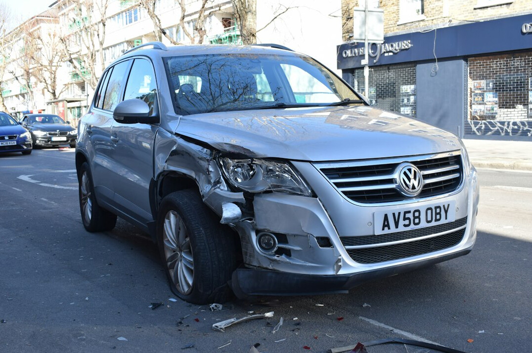 Car with bumper damage being inspected